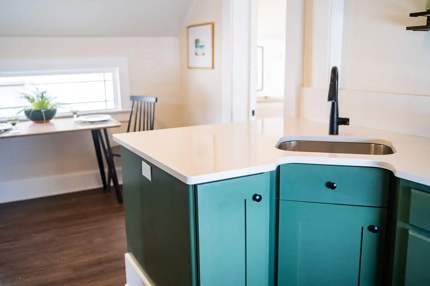 A kitchen with a deep teal island