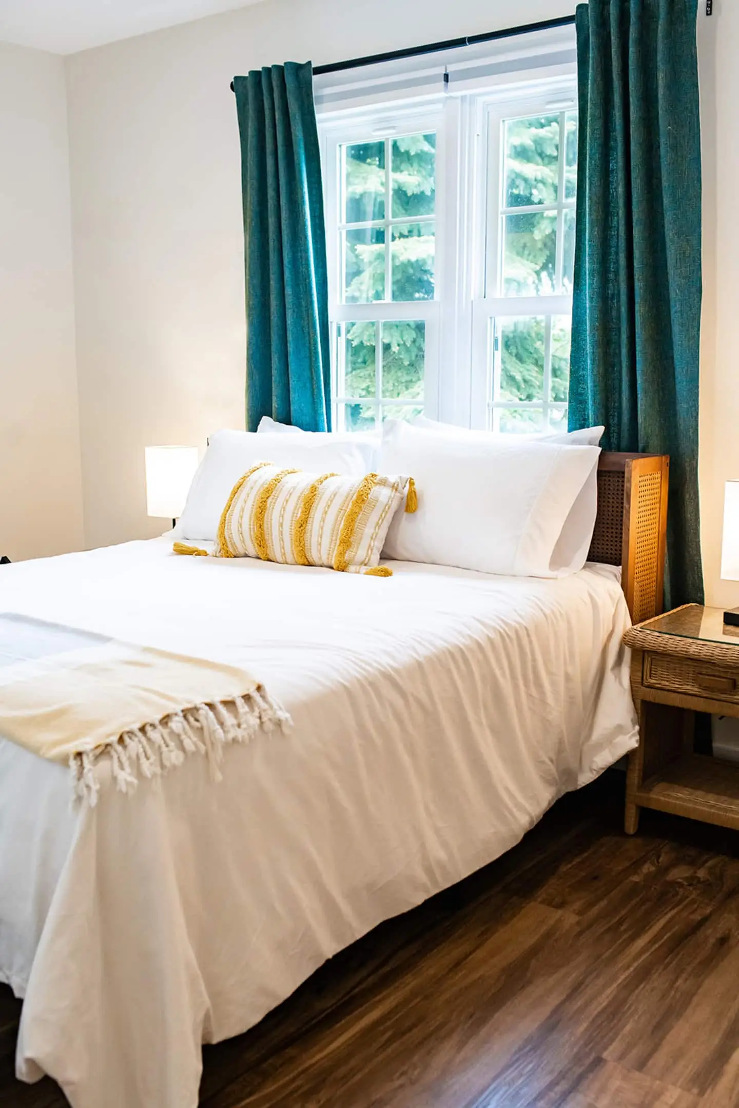 A queen bedroom with warm bedding and soft evening light